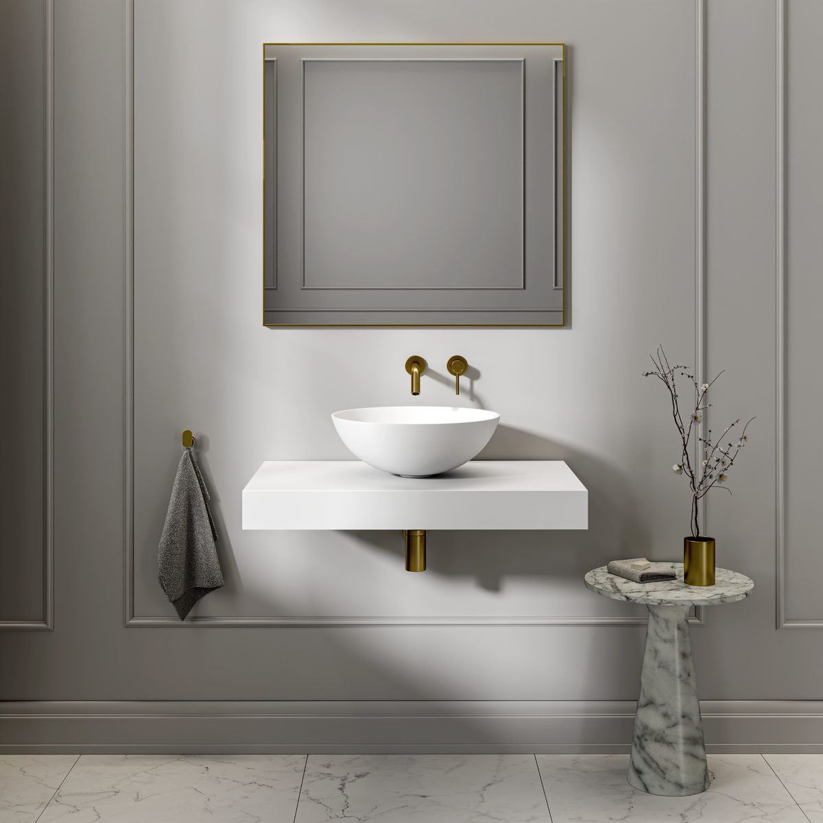 Round white stone countertop basin on a floating shelf below wall-mounted brass taps and a mirror